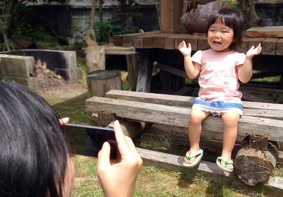 お子さんの写真をスマートフォンで撮影している様子