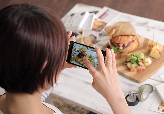 スマートフォンで写真を撮影している女性